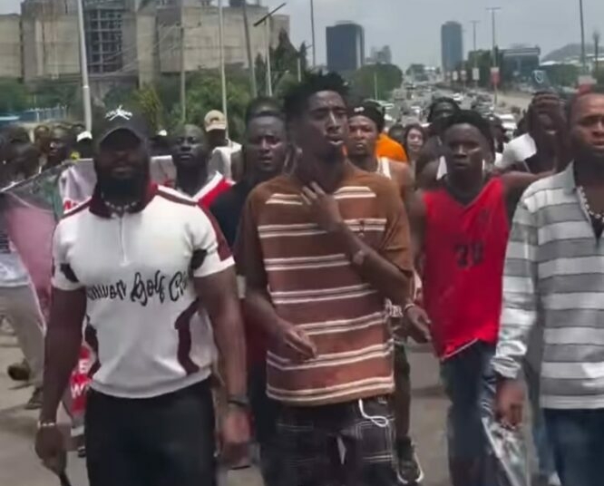 VeryDarkMan Wears School Uniform to Lead Late-Night “Tinubu Must Go” Protest